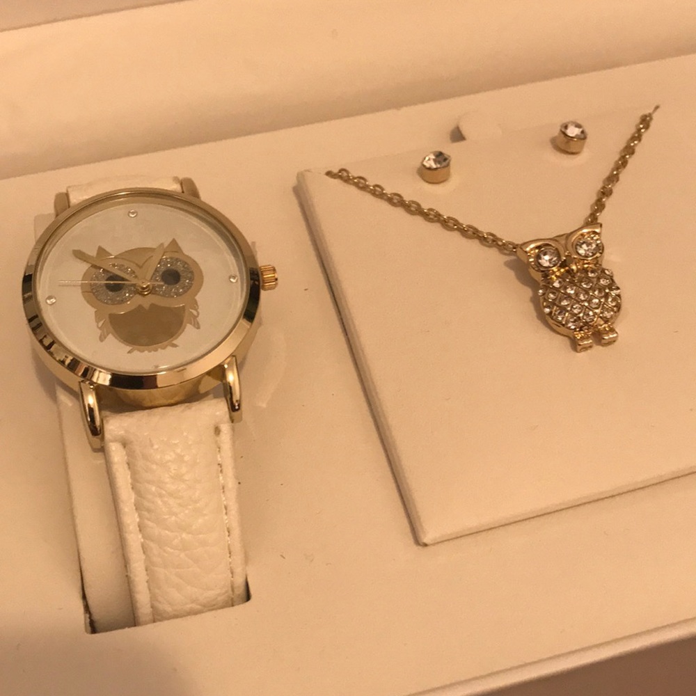 Silver watch with white band. Necklace and earring